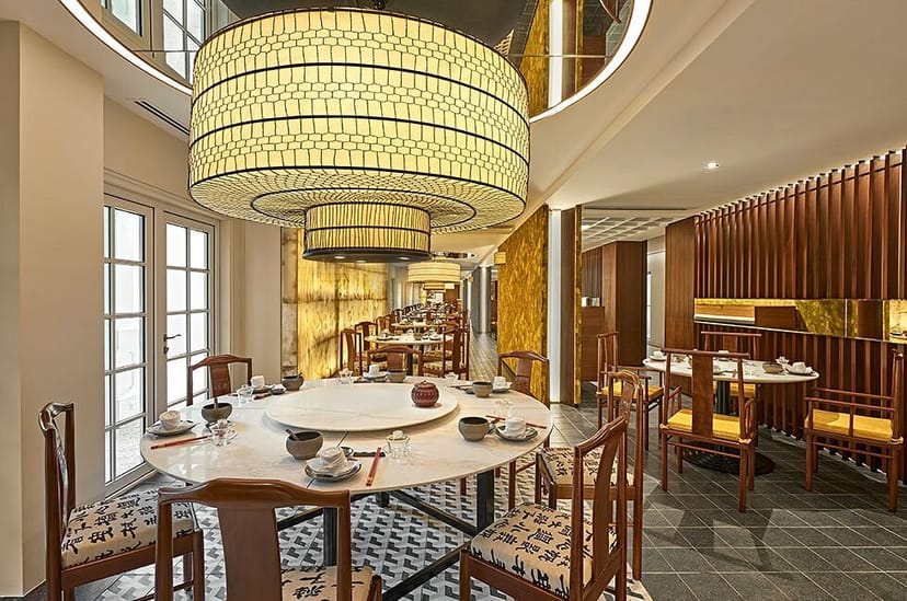 Sophisticated restaurant dining space with chandeliers, ideal for upscale events and meetings.