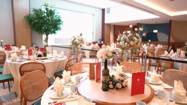 Elegant event space at Red House Seafood with fine china and floral centerpieces.