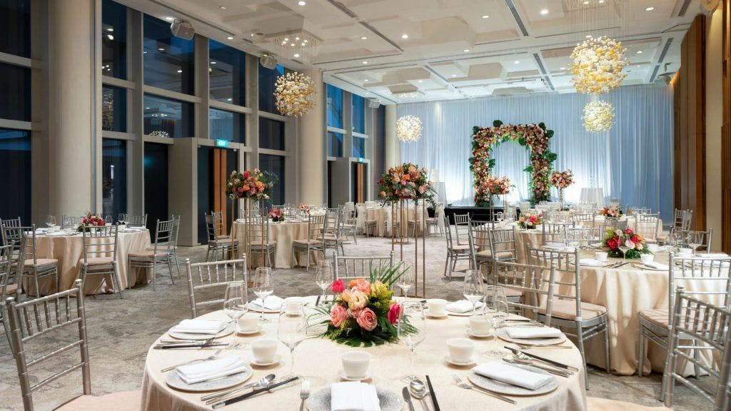 Elegant event space at Oasia Hotels with floral arch, perfect for weddings and gatherings.