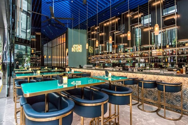 Modern bar area with vibrant blue ceiling, ideal for upscale events and networking.