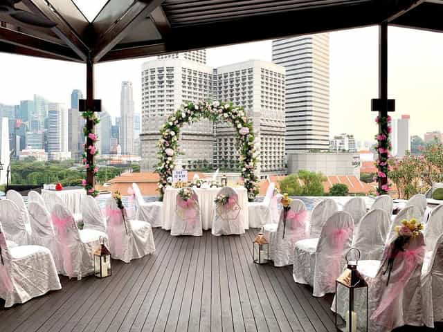Wedding venue at Naumi Hotel Singapore with floral arch and city skyline backdrop.
