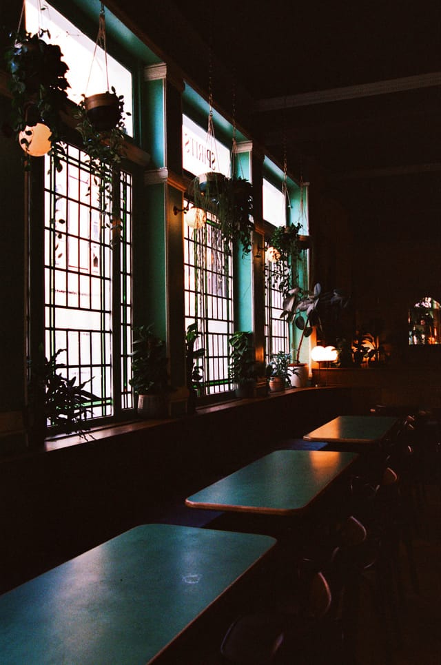 Cozy Marquee Moon Basement with stained glass, ideal for intimate gatherings and networking.