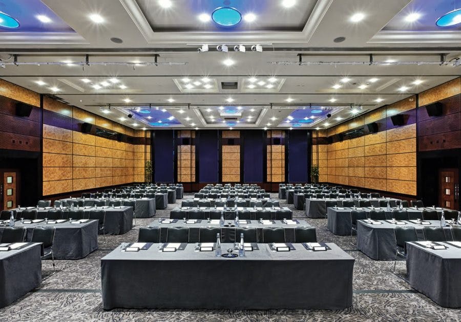 Conference room at Leonardo Royal Hotel London, set up for a large meeting with tables.