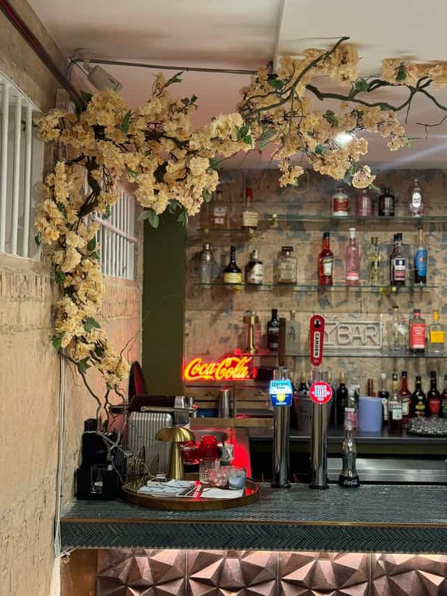 Stylish cocktail lounge bar with neon sign, perfect for social events and gatherings.