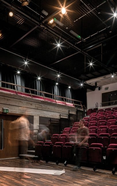 Modern auditorium with tiered seating in Square Chapel Arts Centre for conferences and workshops.