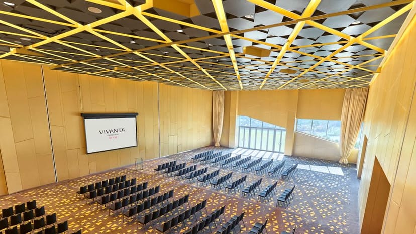 Modern conference venue in Vivanta New Delhi with stylish ceiling and natural light.