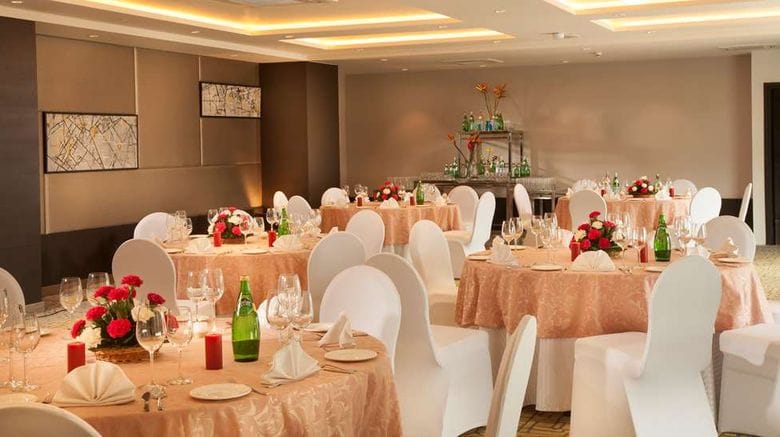 Elegant Conference Hall setup with round tables for weddings and corporate events.