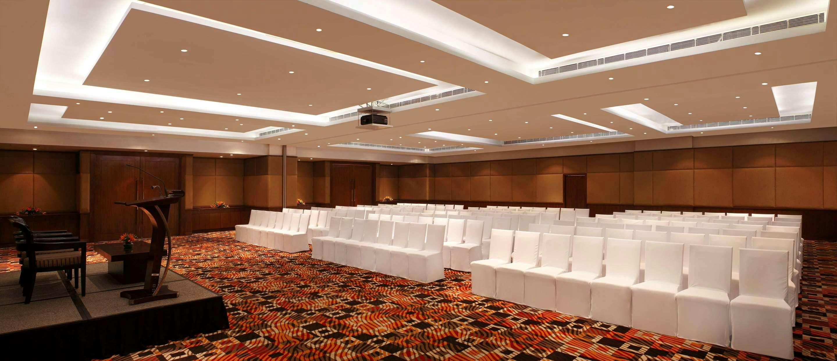 Meeting room with white chairs, ideal for conferences and presentations at DoubleTree Gurgaon.