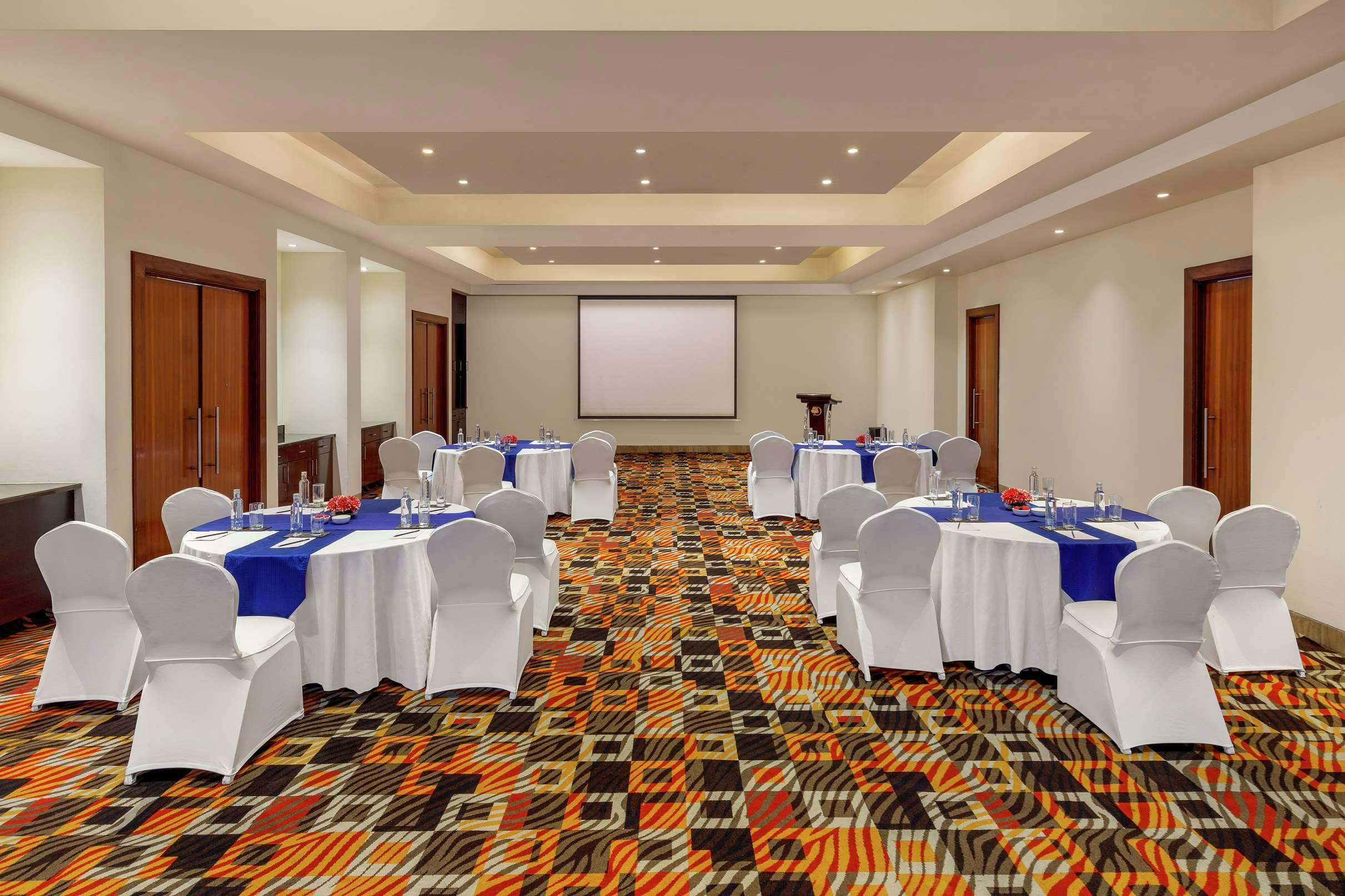 Conference Hall at DoubleTree Gurgaon with round tables, ideal for corporate meetings and workshops.