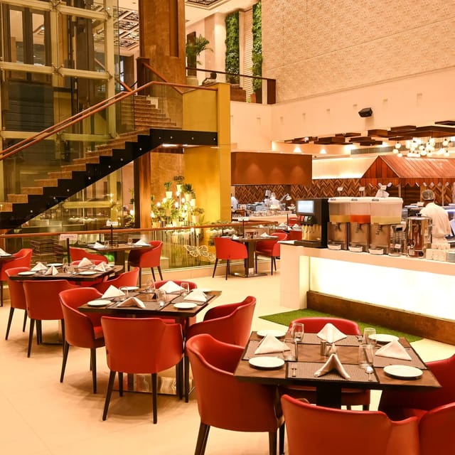 Modern restaurant with red chairs, perfect for networking events and gatherings.