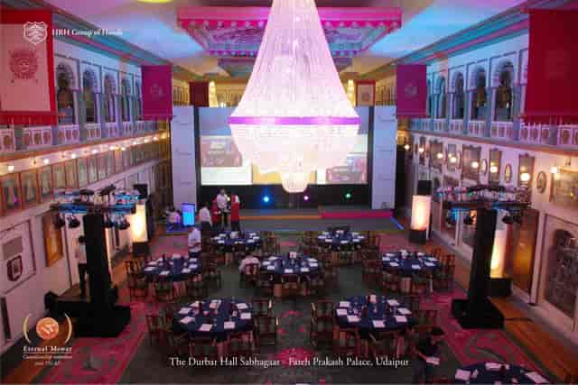 Elegant banquet hall with chandelier, perfect for corporate events and celebrations.