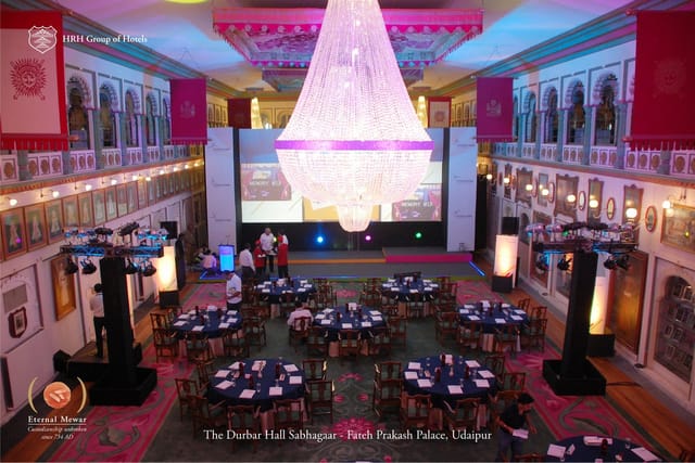 Elegant banquet hall with chandelier, perfect for corporate events and celebrations.