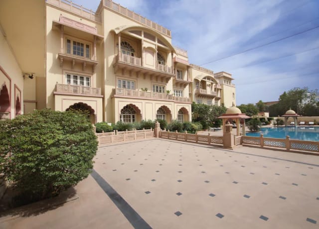 Amar Hall at Taj Hari Mahal: elegant outdoor venue with lush landscaping for weddings and events.