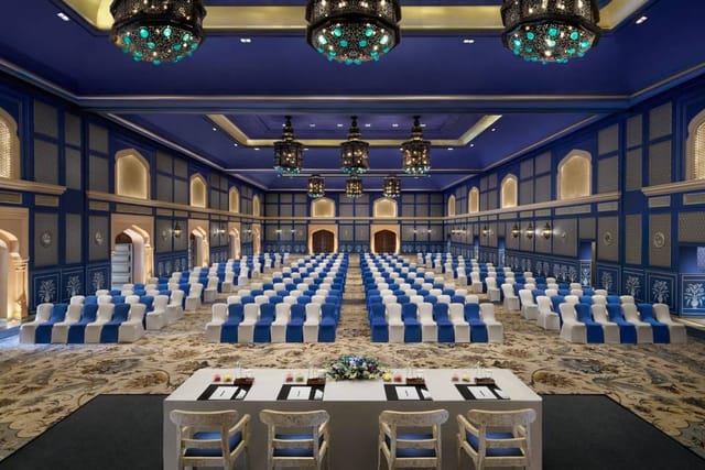Grand Ballroom at Fairmont Jaipur with elegant blue chairs, perfect for conferences.