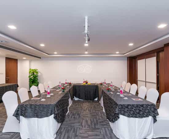 Meeting room at Country Inn & Suites, elegantly set for professional events with floral centerpieces.