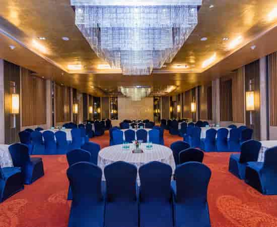 Conference hall at Country Inn & Suites with elegant round tables for corporate events.