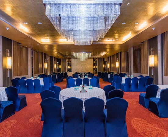 Conference hall at Country Inn & Suites with elegant round tables for corporate events.