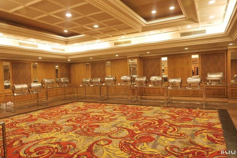 Elegant banquet hall with buffet setup, perfect for weddings and corporate events.