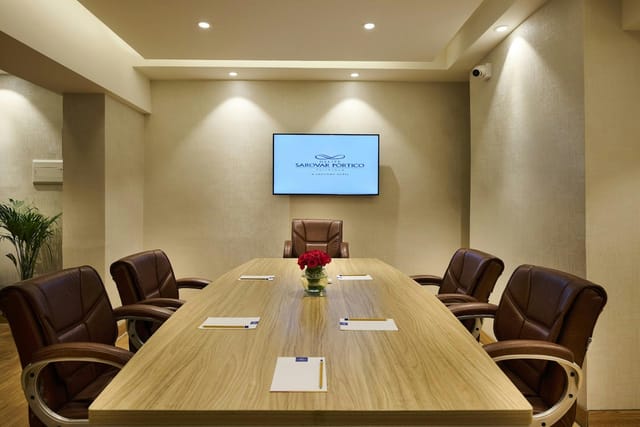 Banquet Hall at Sarovar Hotels, featuring a sleek wooden table for professional meetings.