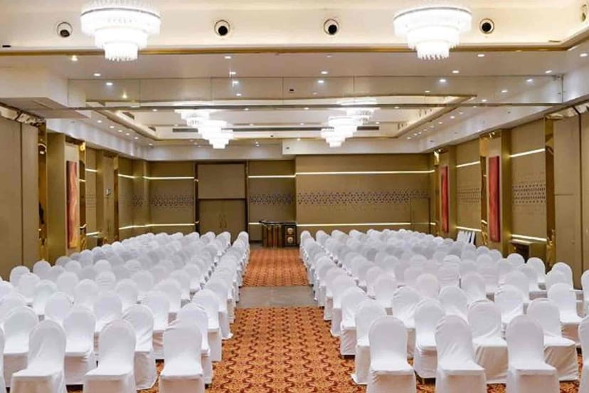 Elegant Imperial Hall setup with white chairs for conferences and formal events.