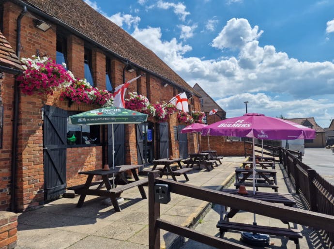 British Beer Garden in The Long Barn with vibrant flowers, ideal for summer parties.