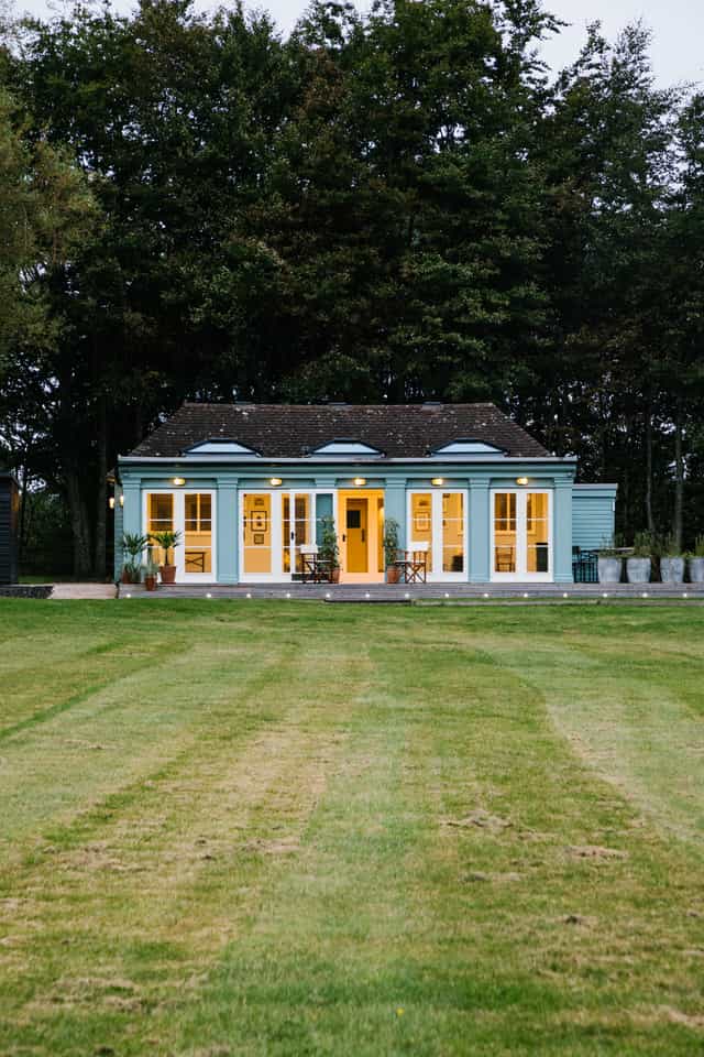 Hawarden Castle Pavilion with blue exterior, ideal for events and retreats.