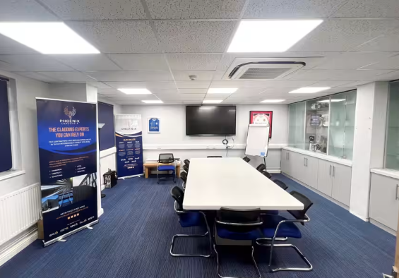 Conference room with central table, ergonomic chairs for professional meetings and events. - Banner