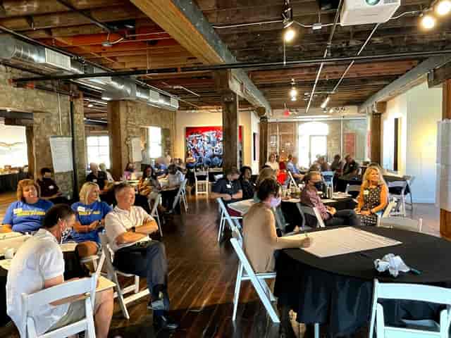 "Fine Arts Gallery meeting with attendees engaged in discussion, ideal for networking events."