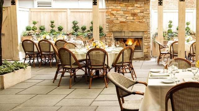 Outdoor dining space at Harvest restaurant with elegant table settings for events.