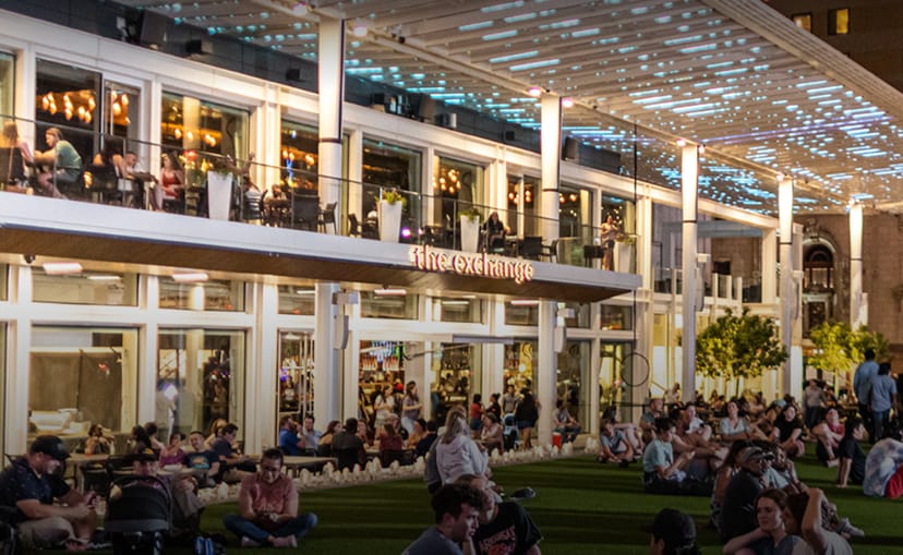 Vibrant outdoor Food Hall venue with modern architecture for casual gatherings and networking.