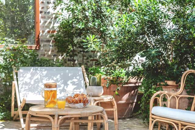 Outdoor meeting space at ibis Styles Paris Nation with greenery and seating for networking events.
