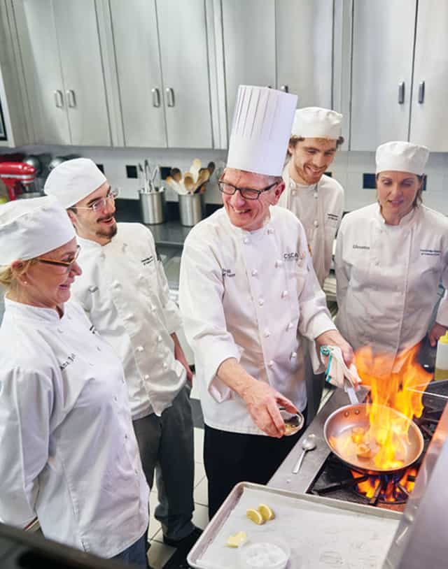 Culinary demonstration at Cambridge School of Culinary Arts, perfect for team-building events.