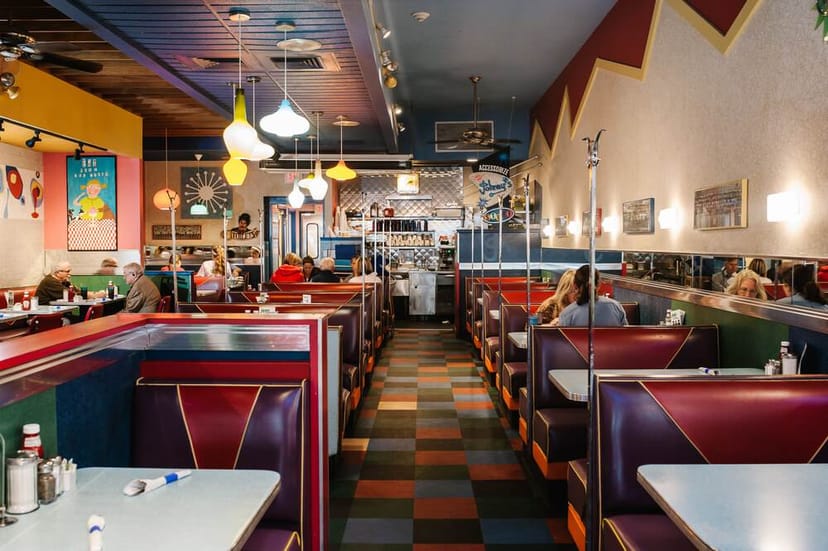 Vibrant diner interior with cozy booths for casual meetings and networking events.