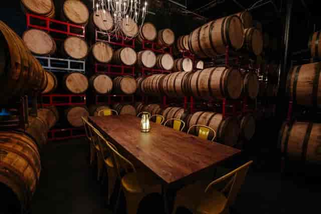 Private event space at Bully Boy Distillers with rustic table and yellow chairs.