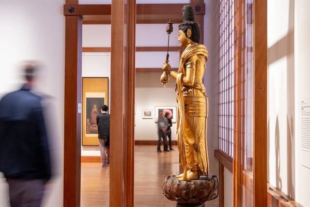 Statue in Boston art gallery, warm wood decor, ideal for events and exhibitions.