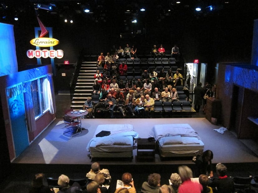 ImprovBoston theater setup with motel scene for engaging performances and events.
