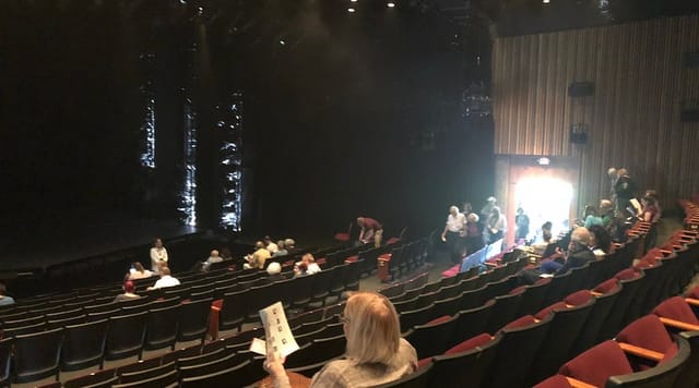 ImprovBoston theater ready for an engaging performance with dim lighting and eager attendees.