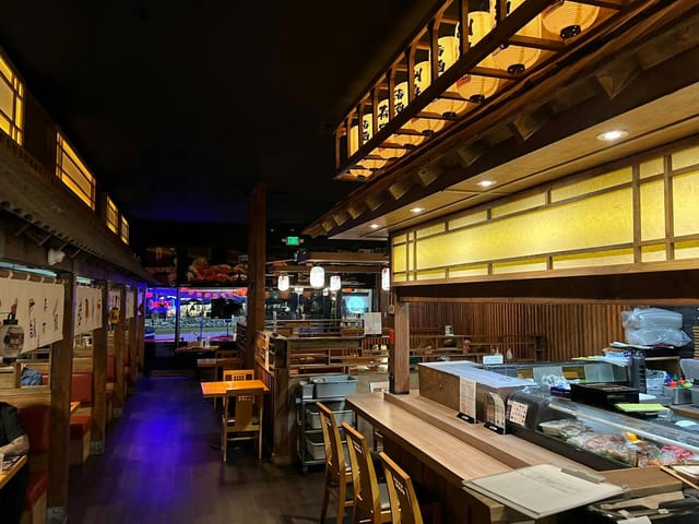 Cozy Oishi Sushi restaurant with warm lighting, ideal for intimate gatherings and events.