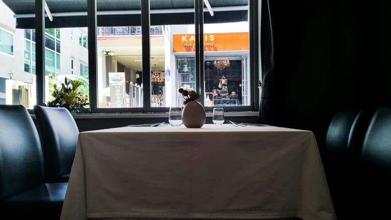 Intimate restaurant table with floral centerpiece, perfect for private dining events.