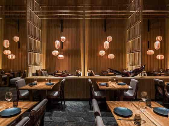 Stylish restaurant with warm lighting, ideal for intimate gatherings and corporate dinners.