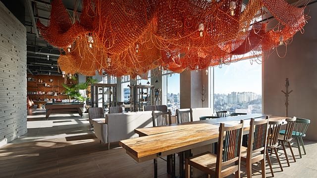 Modern event space at L7 HONGDAE by LOTTE with artistic ceiling, ideal for meetings and gatherings.