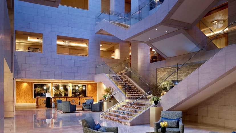 Elegant hotel lobby with grand staircase, ideal for events and conferences in Dubai.