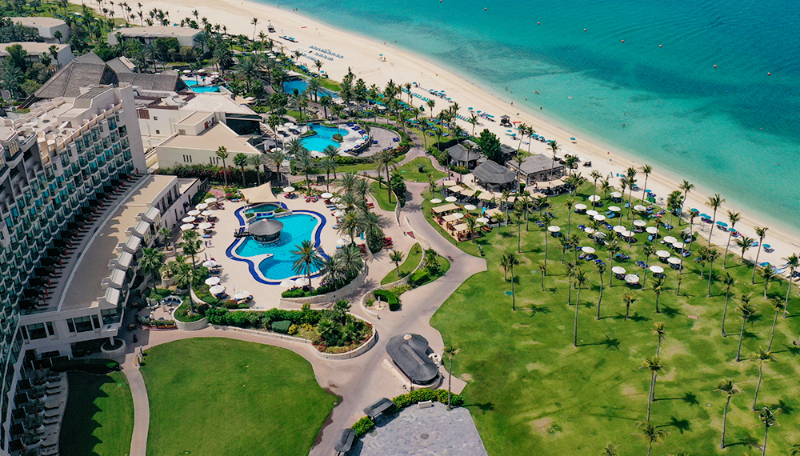 Beachfront resort at JA Beach Hotel, ideal for events and meetings with lush outdoor spaces.