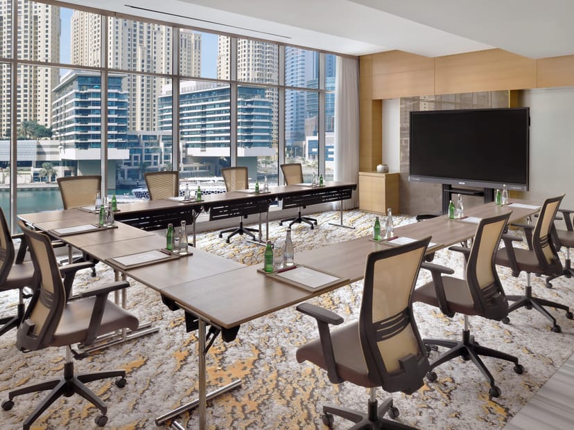 Modern conference room with large windows, ideal for corporate meetings and workshops.