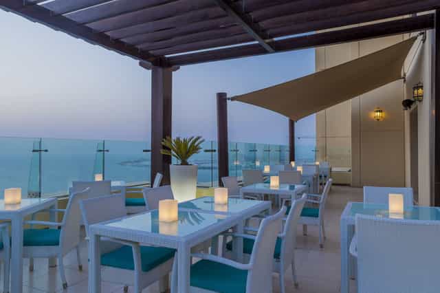 Sky bar at Hilton Dubai: stylish outdoor venue with ocean view for upscale events.