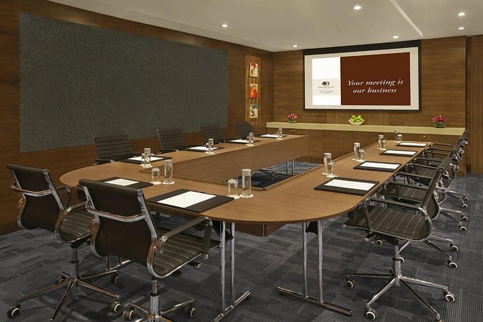 Modern conference room with oval table at Hampton by Hilton Dubai for professional meetings.