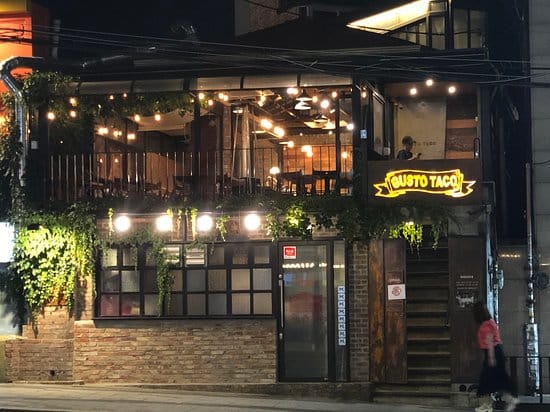 Vibrant Gusto Taco restaurant exterior with outdoor seating for casual events.