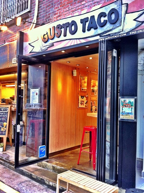 Modern restaurant entrance with warm wood paneling, ideal for networking events.