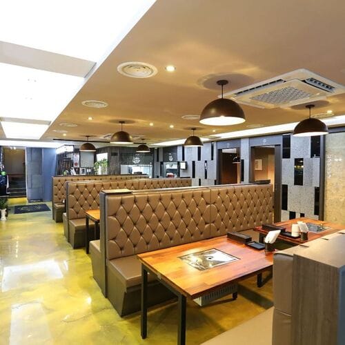Modern restaurant interior with spacious booths in Eatanic Garden, ideal for events and gatherings.