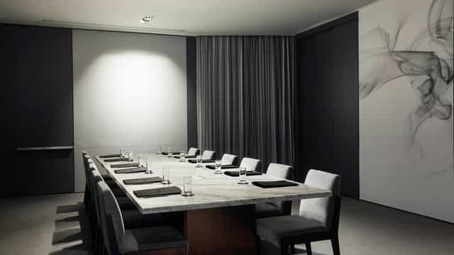 Modern conference room with marble table at Talk & Play, ideal for meetings and events.